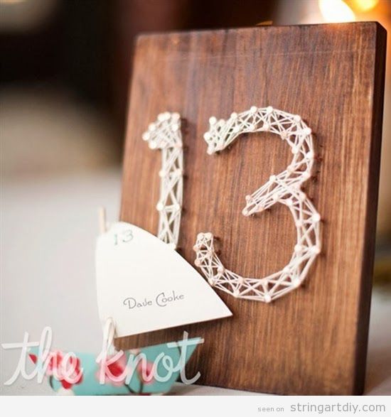 Table numbers on a wedding made with String Art