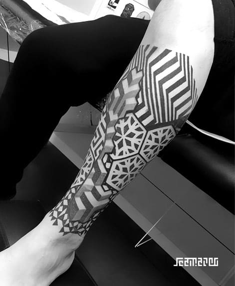 Geometric leg sleeve tattoo